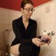 A brunette, naked Canadian girl wearing glasses takes a piss and a shit while sitting on a toilet and playing with her cell phone. Very subtle plop sounds can be heard. She wipes her ass when finished. Presented in 720P HD. Over 8 minutes.